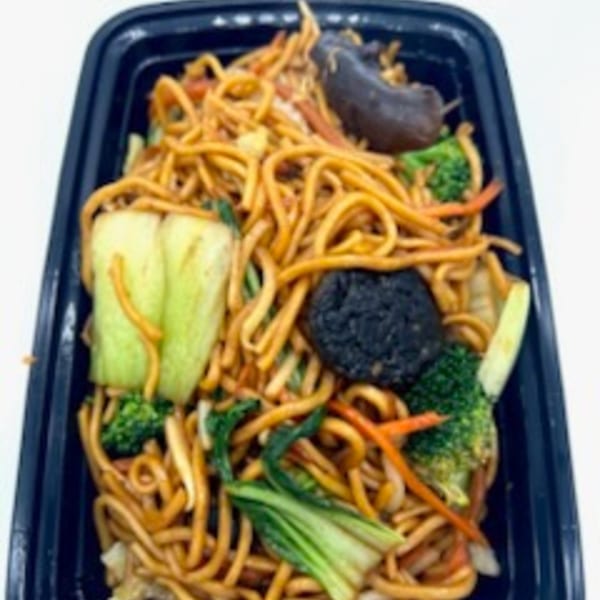 Vegetarian lo mein noodles with broccoli, bok choy, carrots, and mushrooms in a black container.