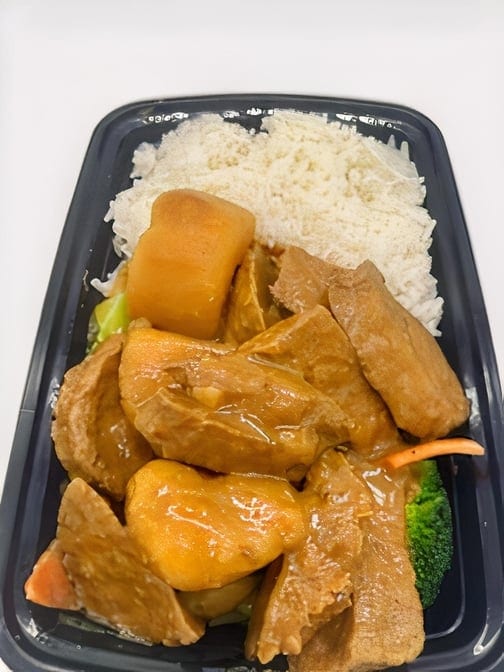 Curry chicken cooked in coconut milk lunch special.